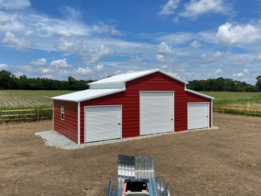 a red and white traditional steel barn