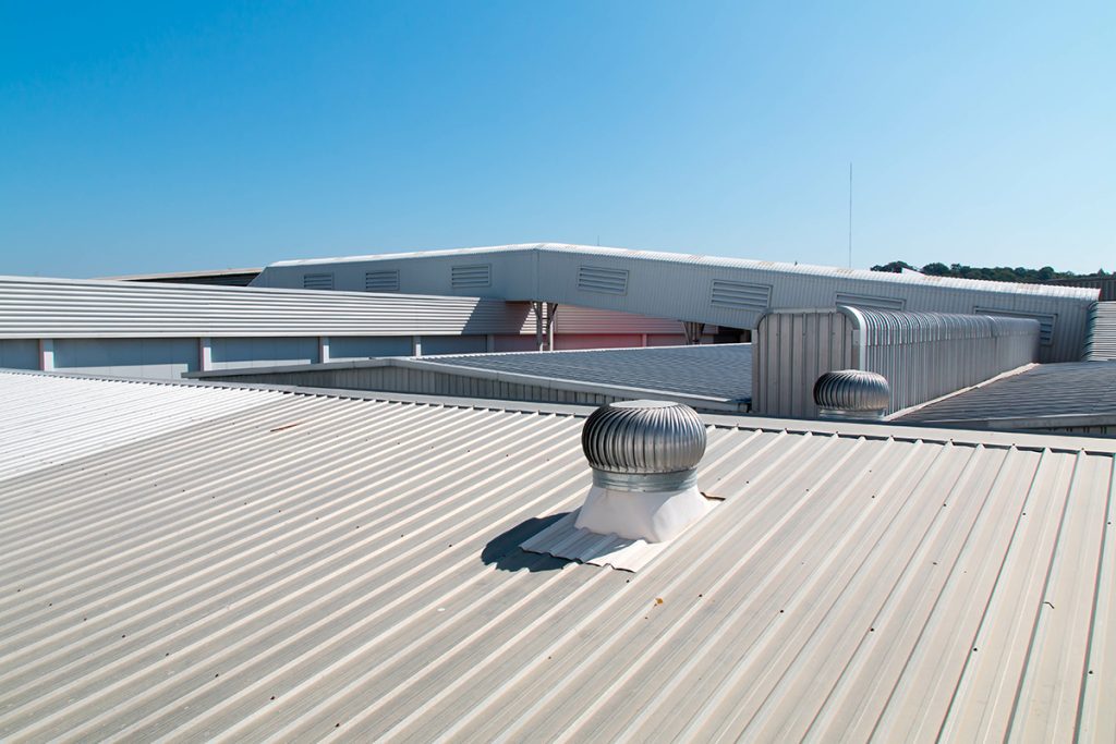 A view of a metal building with multiple vents