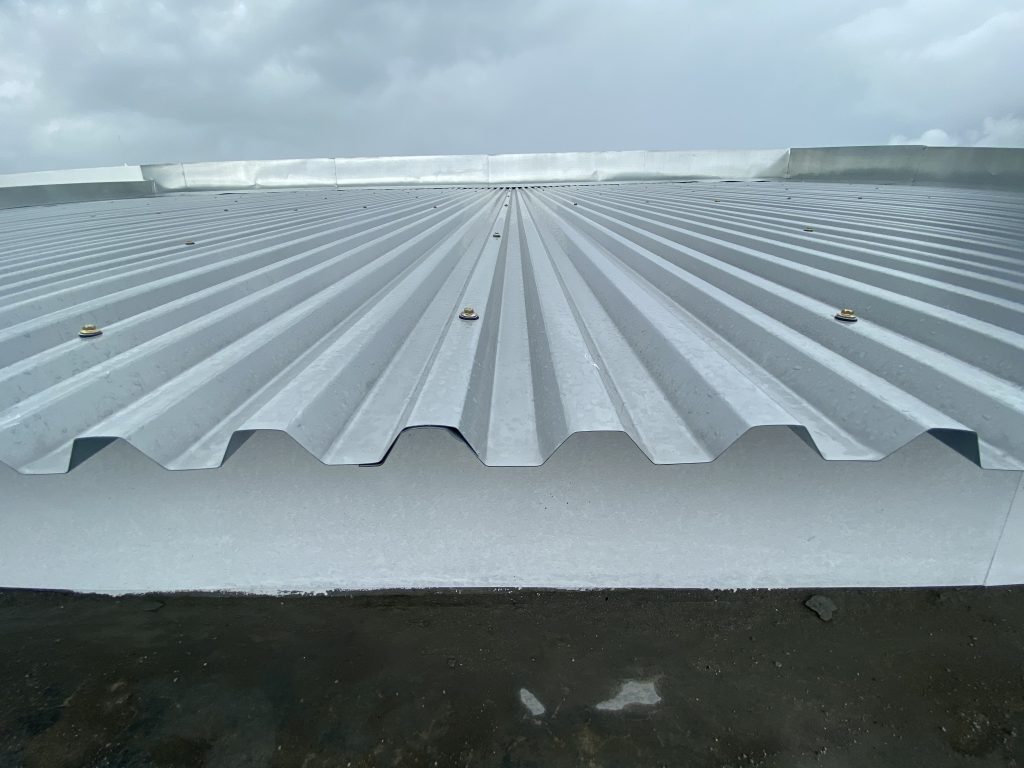 A close view of a corrugated metal roof from below