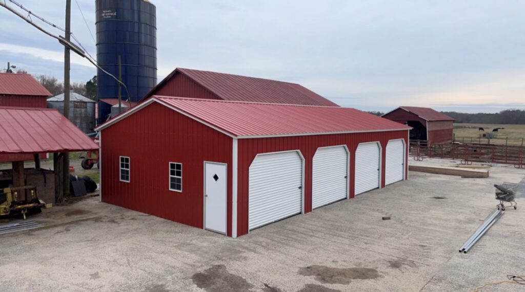 A large red metal barn on a farm